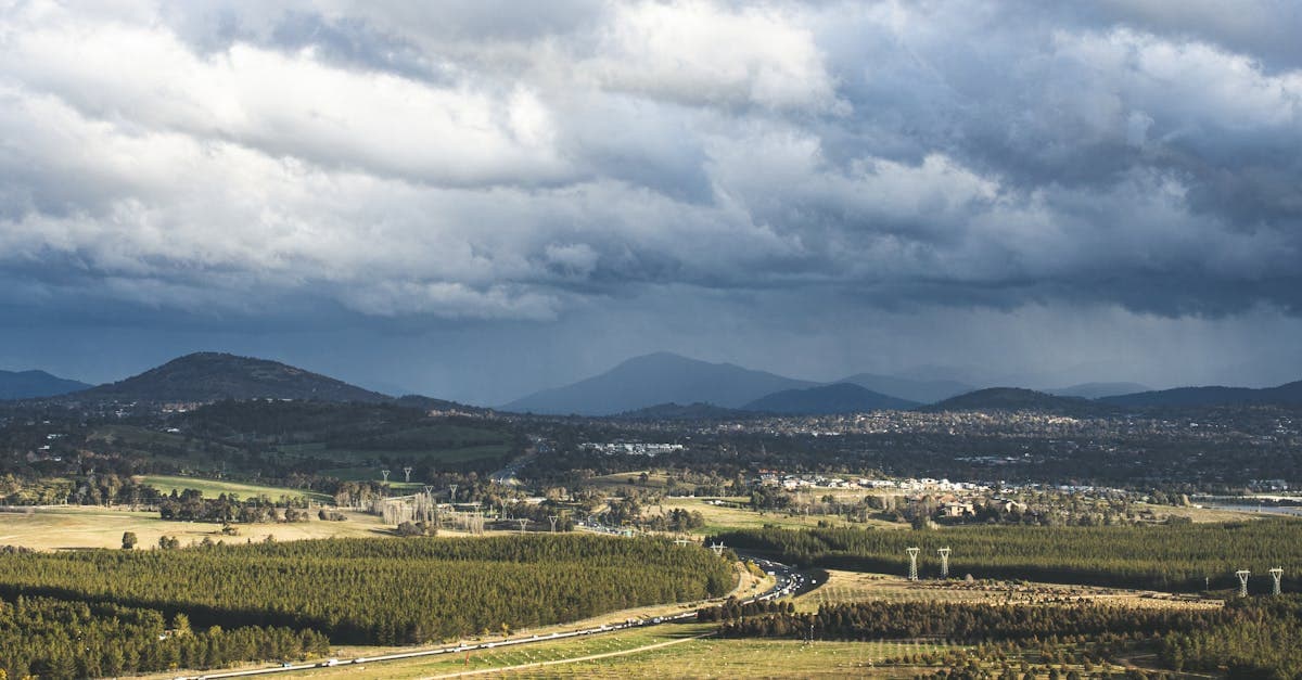 Stunning aerial view of Canberra's countryside with dramatic clouds overhead.